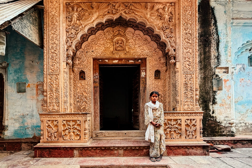 This local girl was delighted to pose for our group, backdropped by one of the crumbling former mansions in the heritage village of Uttar Pradesh (image by Virginia Wilde)