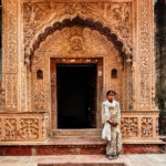 This local girl was delighted to pose for our group, backdropped by one of the crumbling former mansions in the heritage village of Uttar Pradesh (image by Virginia Wilde)