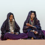Beautiful Tuareg girls adorned in indigo and silver in the desert (image by Inger Vandyke)
