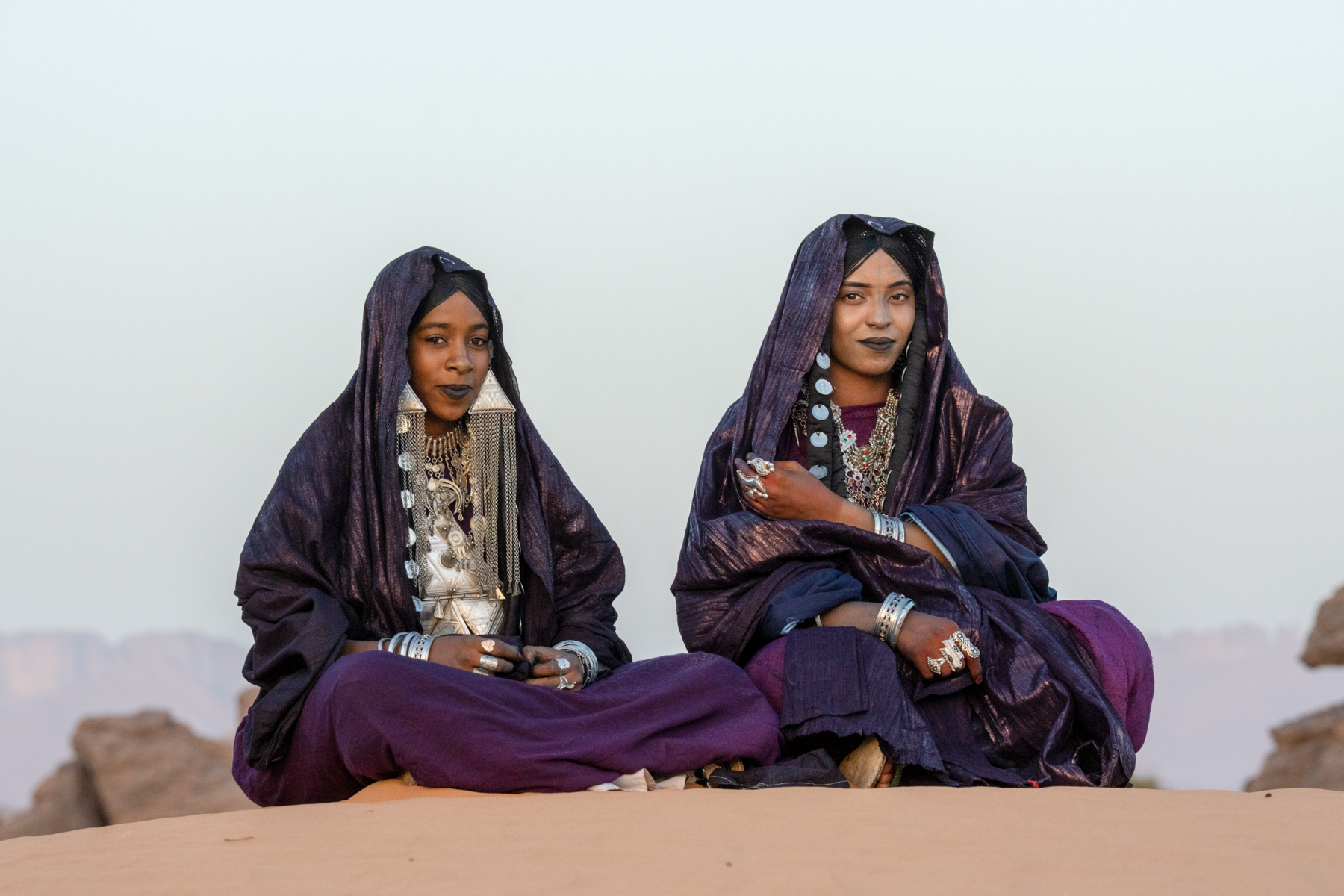 Beautiful Tuareg girls adorned in indigo and silver in the desert (image by Inger Vandyke)