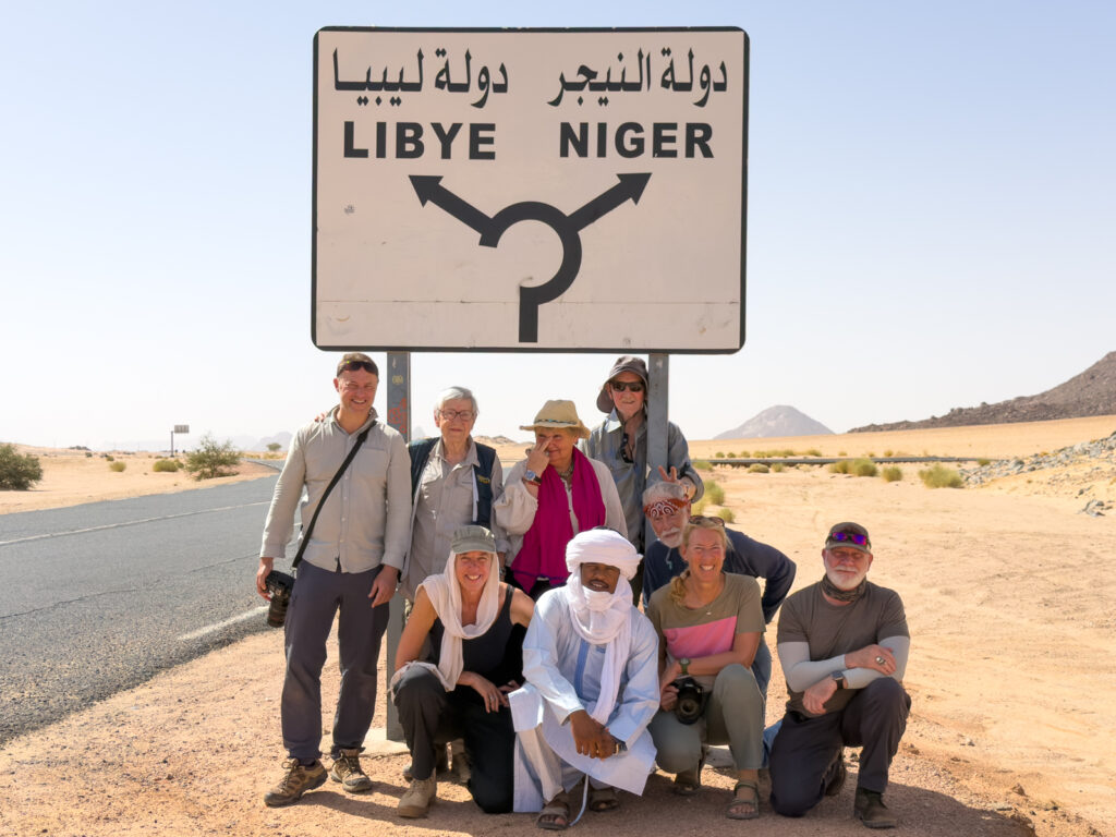 Our group all looking fresh and ready for five days in the desert. We stopped at the famous road junction sign for obligatory tourist shots (image by Inger Vandyke)