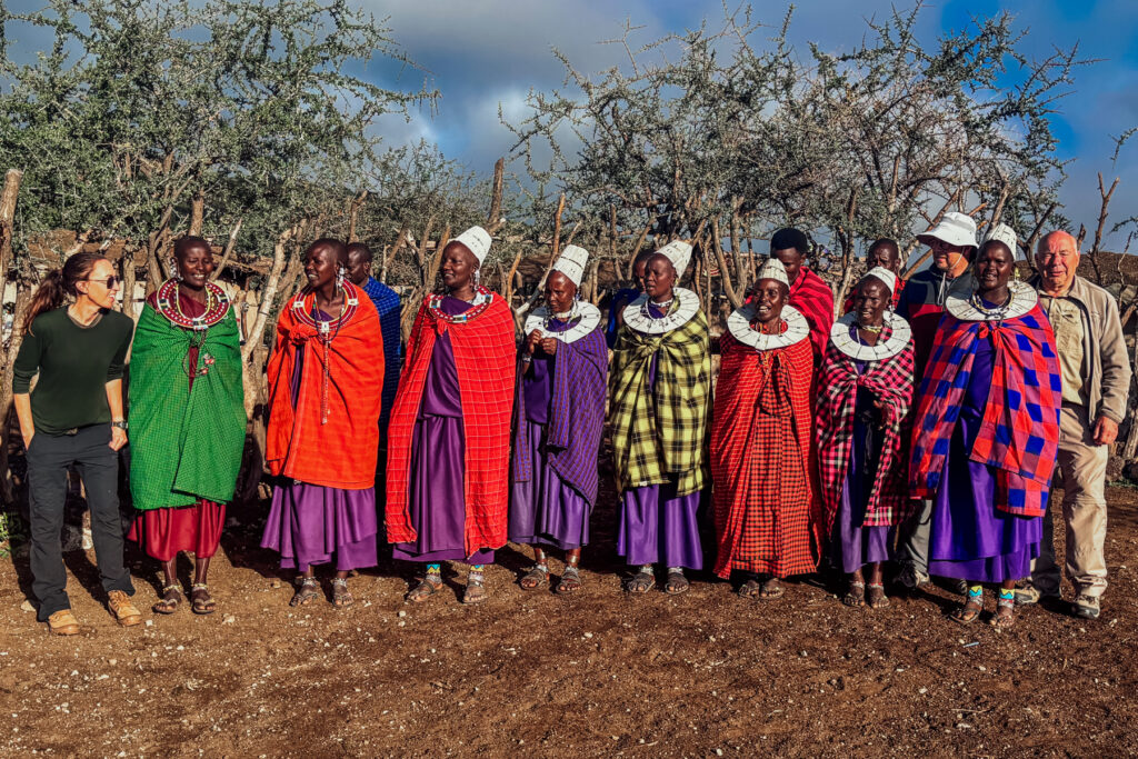 Maasai women demonstrate how to sing and dance properly - while a small group of tour members attempt to join the merriment (image by Virginia Wilde)