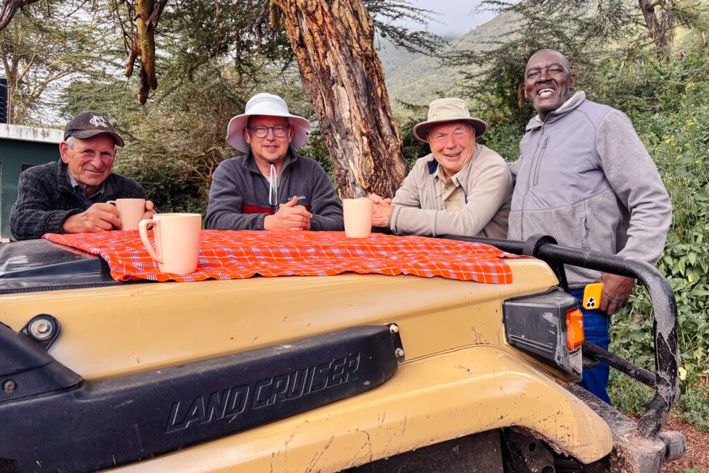 Tour members enjoy a coffee break in Ndutu with our lovely driver /co-guide Exaud, aka 'Eggy' (image by Virginia Wilde)