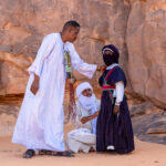 Men prepare a young Tuareg boy for a ceremony of Tahamat (image by Inger Vandyke)