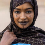 Traditionally, face makeup for Tuareg women involved yellow ochre foundation with markings created in black kohl (image by Inger Vandyke)