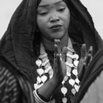 A Tuareg woman clapping her hands at a ceremony of Tahamat in the desert (image by Inger Vandyke)