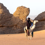 Tuareg cameleer in desert (image by Inger Vandyke)