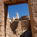 The tiny mud mosque of Zalouaz seen through a stone doorway of the K'Sour (image by Inger Vandyke)
