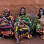 A group of Borana women laugh as they weave baskets (image by Inger Vandyke)