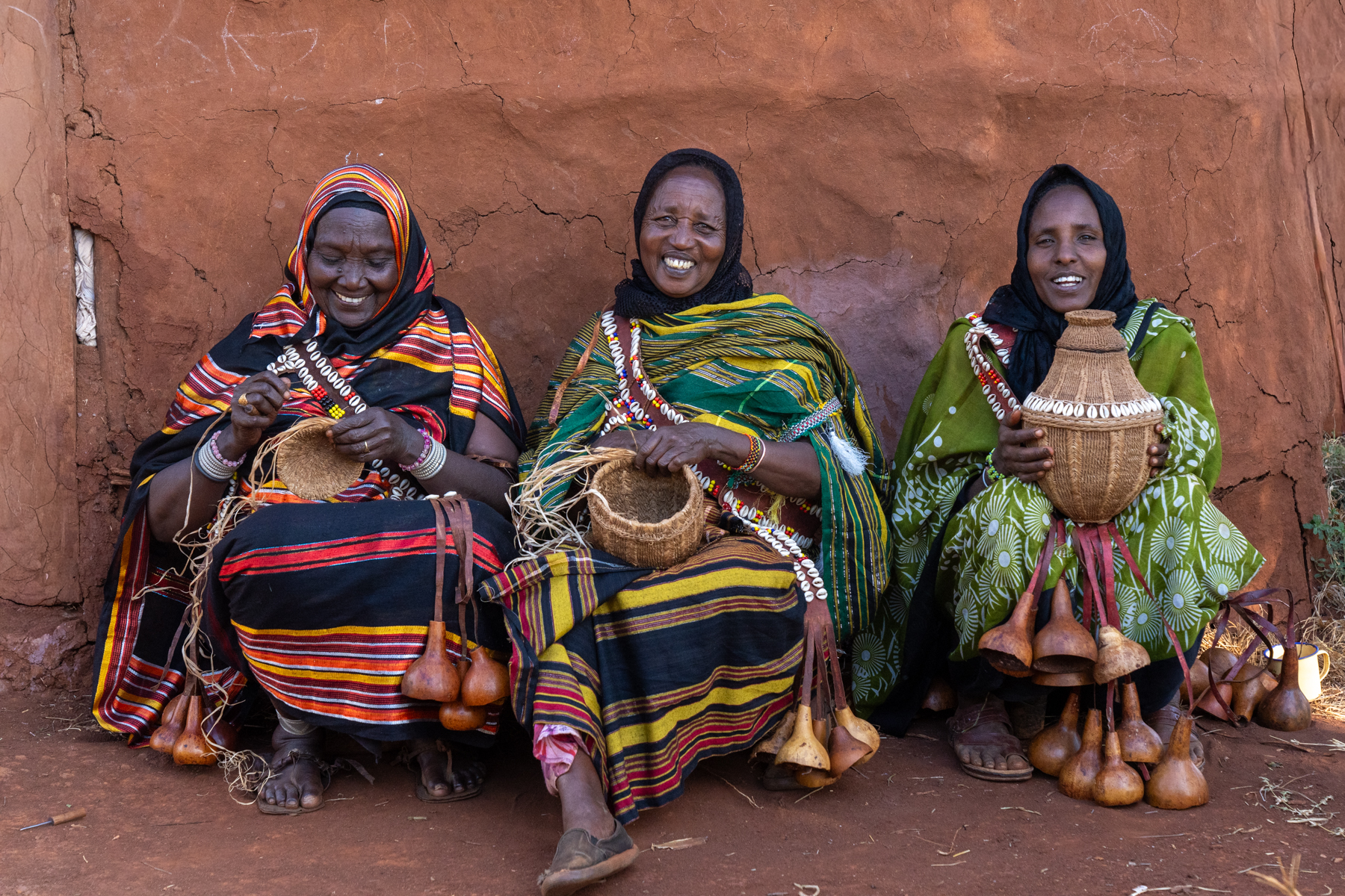 A group of Borana women laugh as they weave baskets (image by Inger Vandyke)