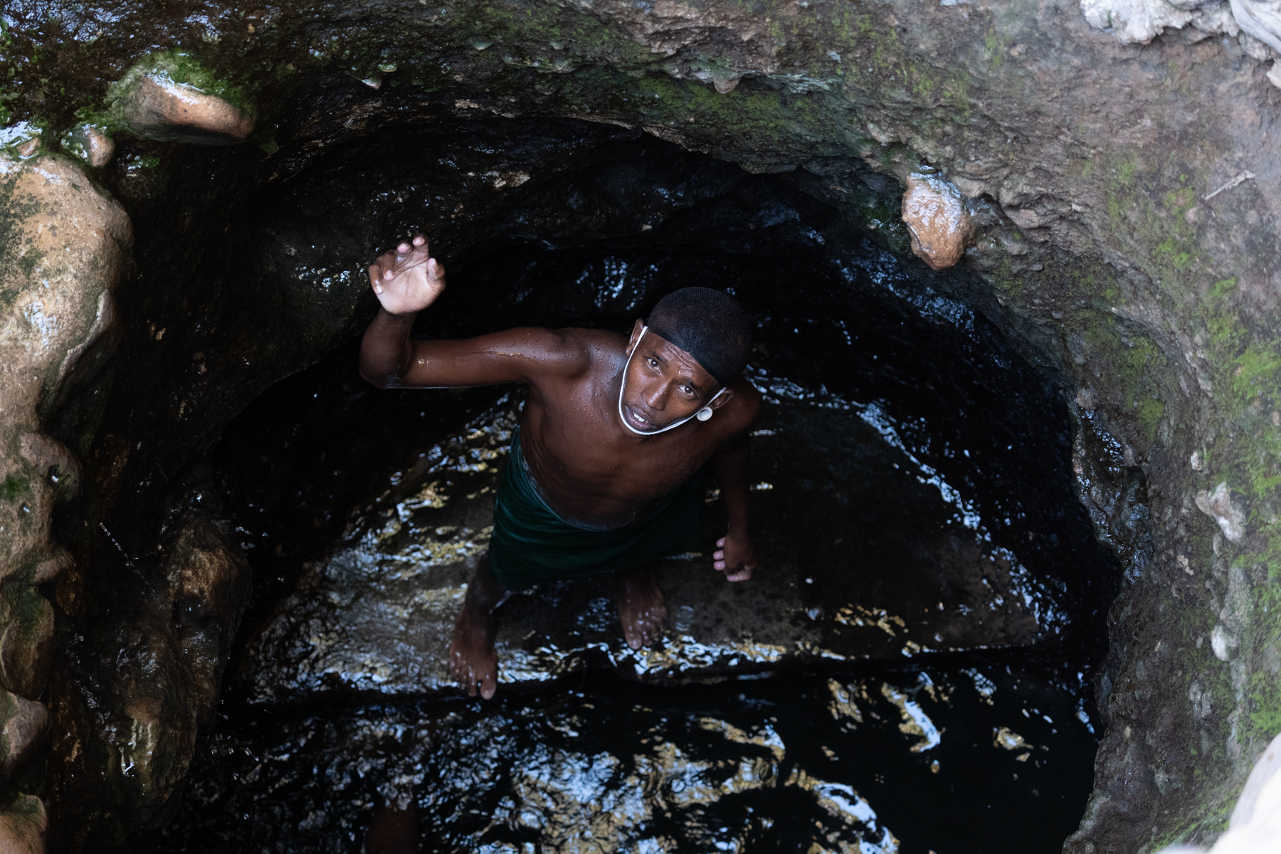 Young Rendille man at the bottom of a singing well (image by Inger Vandyke)