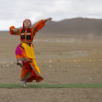 A young dancer in traditional dress performs during the Eagle festival (image by Ingrid Koedood)
