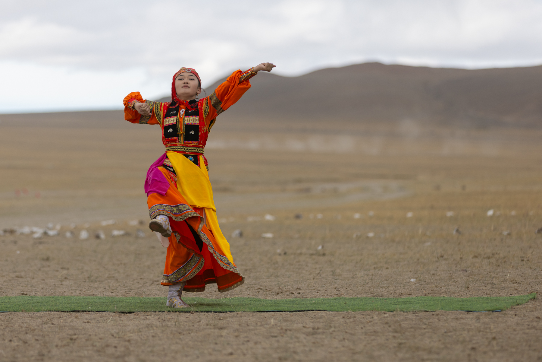 A young dancer in traditional dress performs during the Eagle festival (image by Ingrid Koedood)