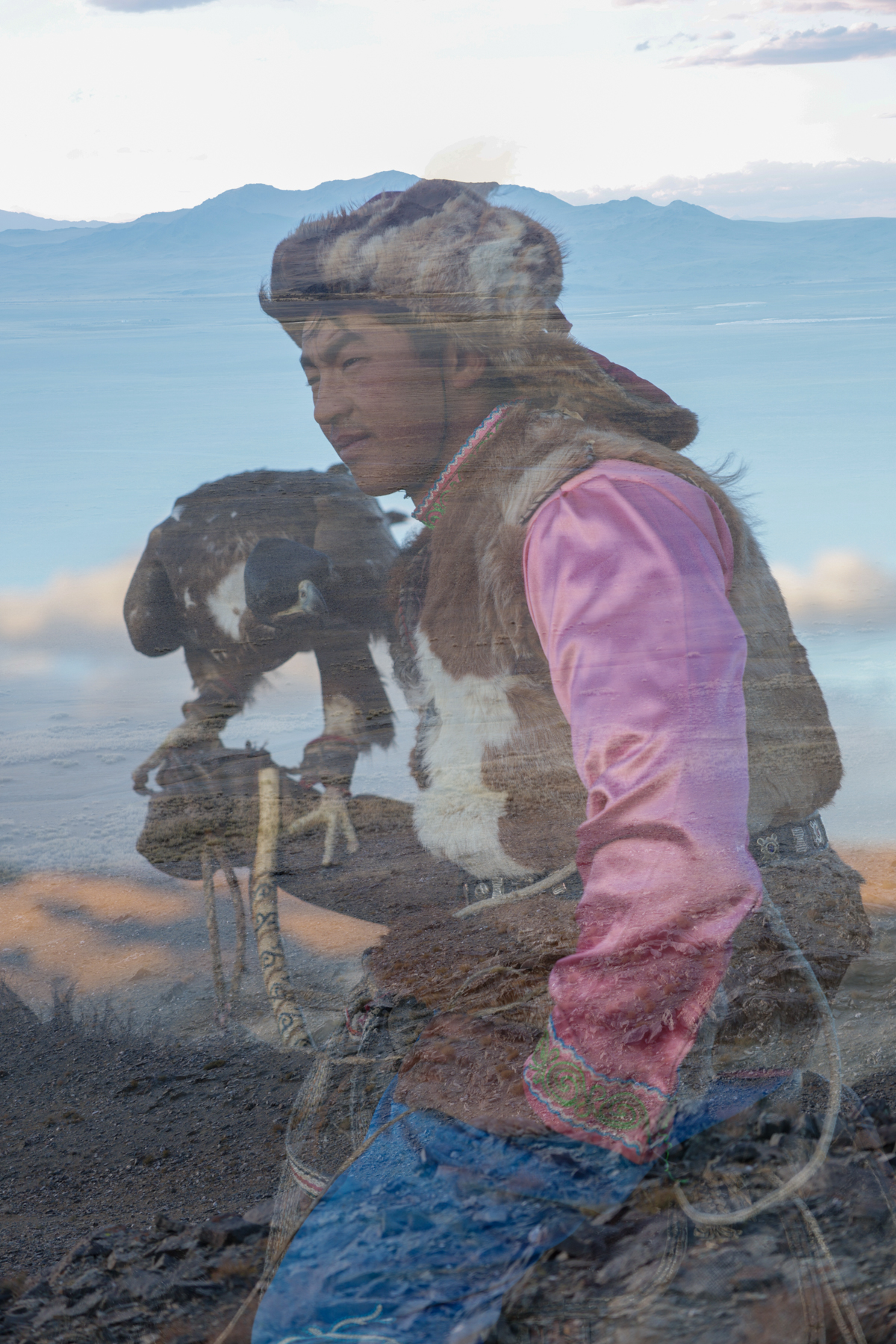 A double-exposure portrait of a young eagle hunter, his face merging with the landscape that shapes his life (image by Ingrid Koedood)