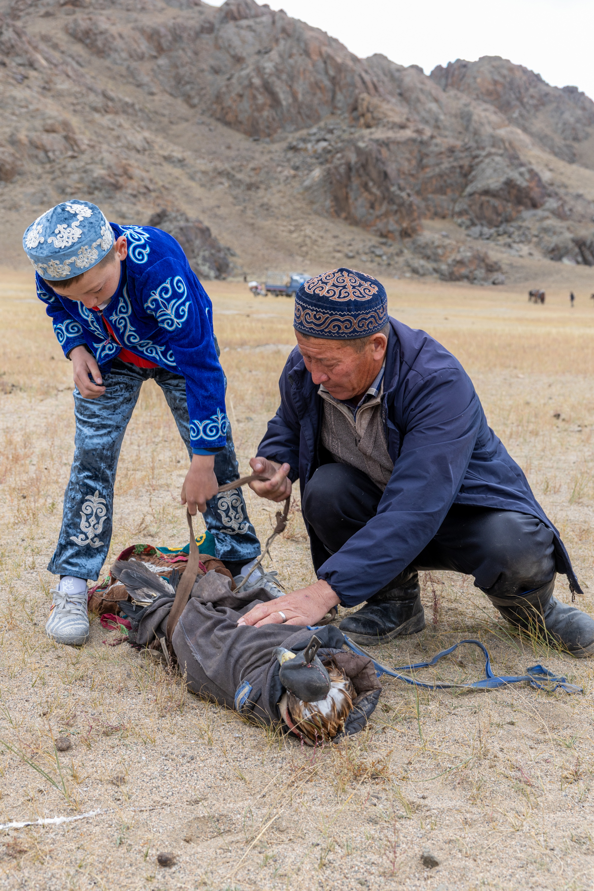 Arriving at the Eagle Hunters festival, a golden eagle is carefully unwrapped after its journey (image by Ingrid Koedood)
