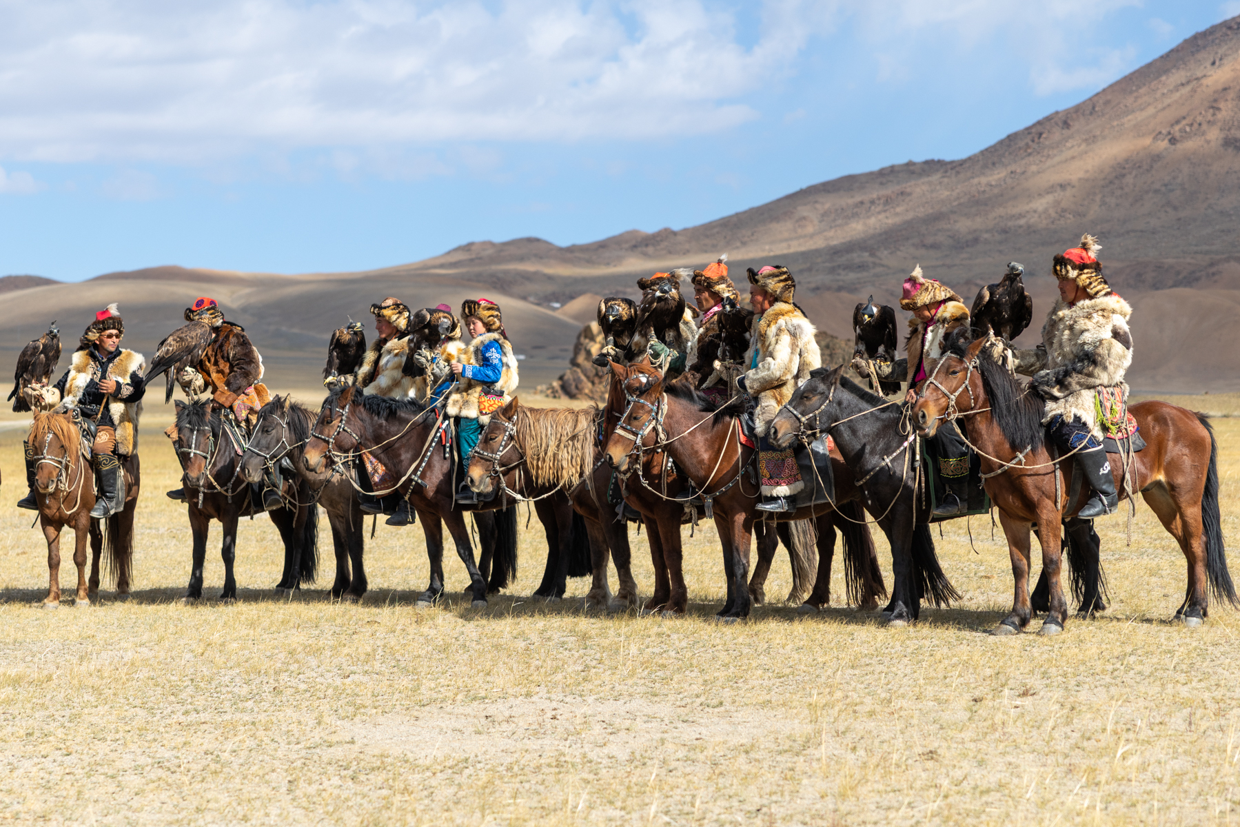 Eagle hunter and their eagles waiting for their turn to compete at the Eagle Hunters festival (image by Ingrid Koedood)