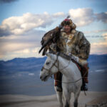 In the mountains, Baurjan poses with his eagle and horse (image by Ingrid Koedood)