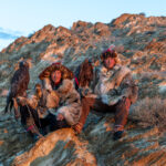 Two Kazakh eagle hunters with their golden eagles at sunrise, during our stay with their family (image by Ingrid Koedood)