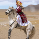 A moment of victory for 16-year-old Aymoldir, celebrating on horseback after she and her partners won the partner-chasing competition at the Eagle Festival (image by Ingrid Koedood)