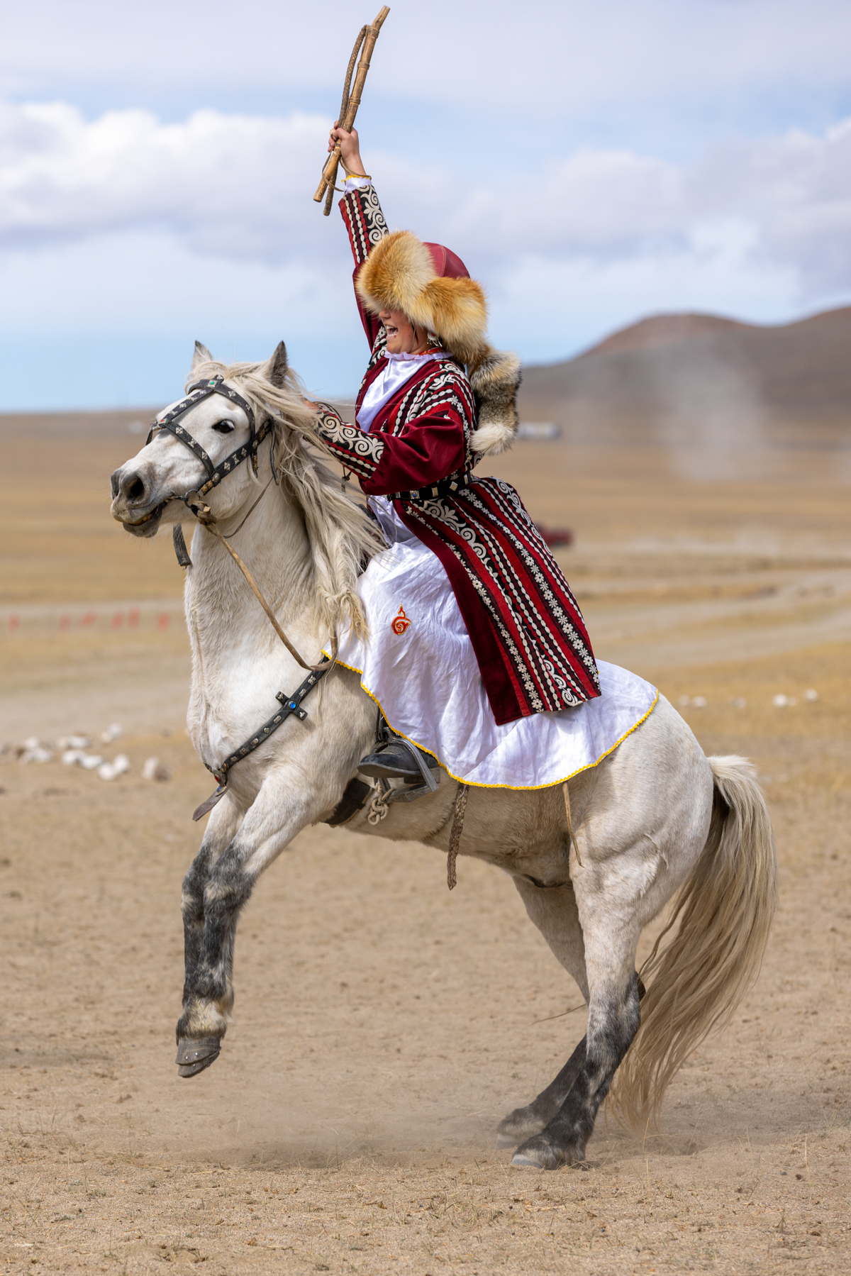 A moment of victory for 16-year-old Aymoldir, celebrating on horseback after she and her partners won the partner-chasing competition at the Eagle Festival (image by Ingrid Koedood)