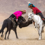 Kokbar, a traditional horseback competition in which riders battle for possession of a headless goat carcass, testing both strength and horsemanship (image by Ingrid Koedood)
