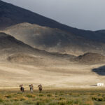 Three eagle hunters make their way across the vast mountain landscape of western Mongolia (image by Ingrid Koedood)