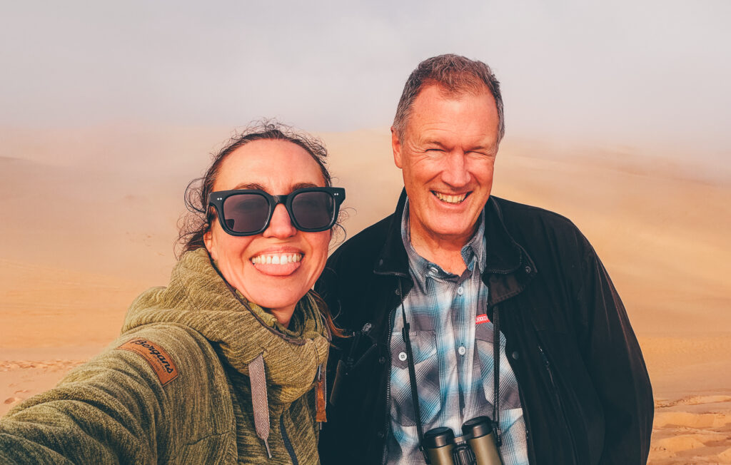 A rare photograph of any Wild Images tour leaders pictured together. Mike Watson and Gin Wilde attempt a selfie during our Sandwich Harbour dune driving day (image by Virginia Wilde)