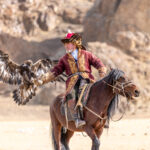 The game of Shakiru, the eagle flies back to its hunter and lands on his arm (image by Ingrid Koedood)