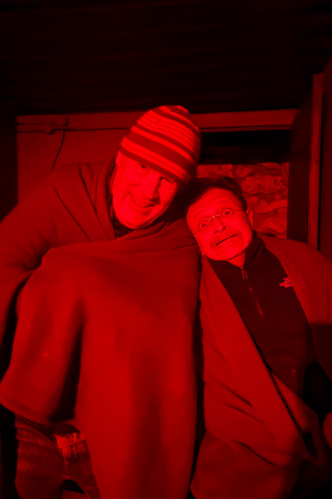 Larking about in the red nightlights of the wonderful Onkolo Hide - where co-leader Mike looks increasingly like TV star Jeremy Clarkson and tour-member KC looks frankly terrified (image by Virginia Wilde)