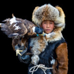 A young eagle hunter with his golden eagle, a bond built through daily care, training and trust from an early age (image by Ingrid Koedood)