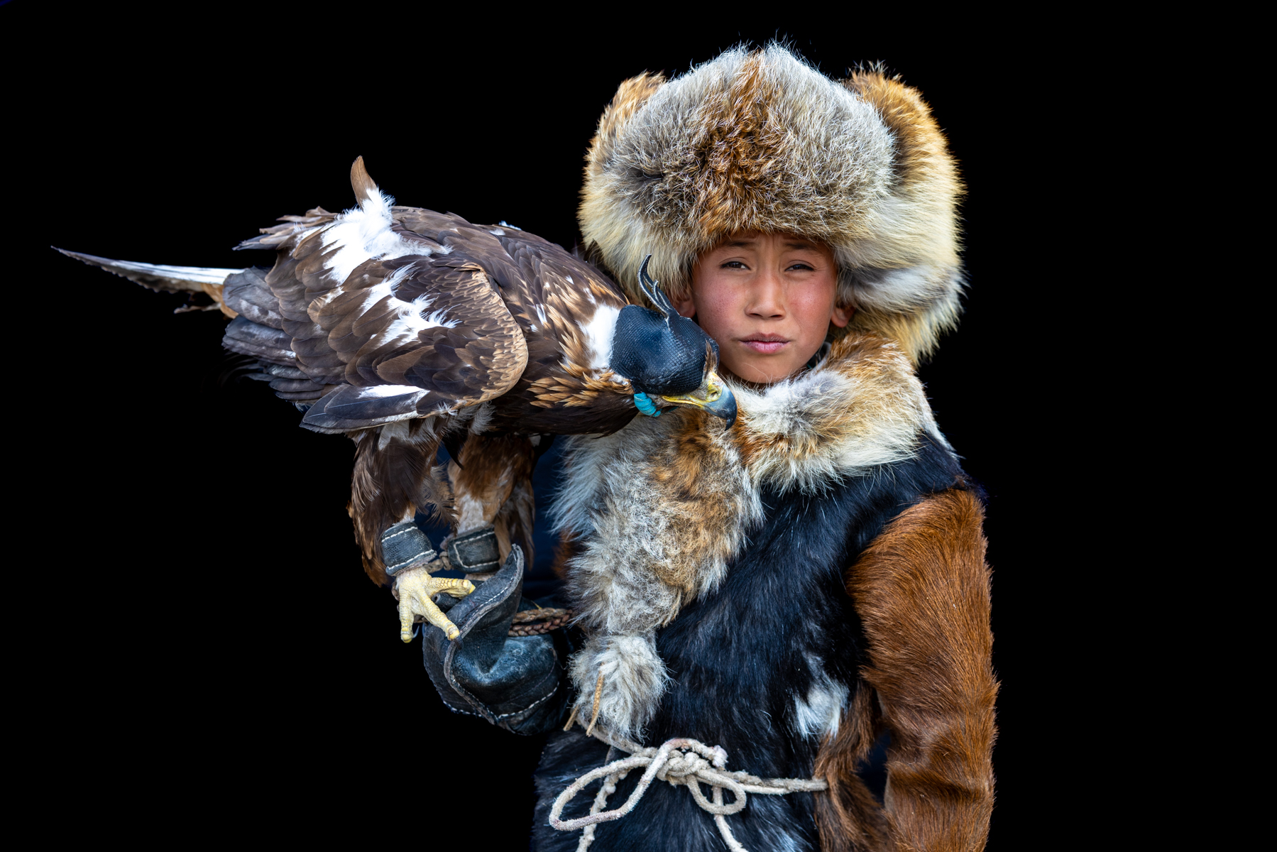 A young eagle hunter with his golden eagle, a bond built through daily care, training and trust from an early age (image by Ingrid Koedood)