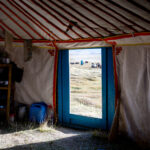 Looking out from inside the yurt, while the yaks are being milked just outside (Image by Ingrid Koedood)